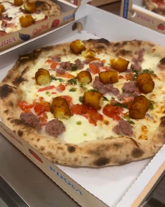 Pizze appena sfornate nei cartoni, pronte per il ritiro